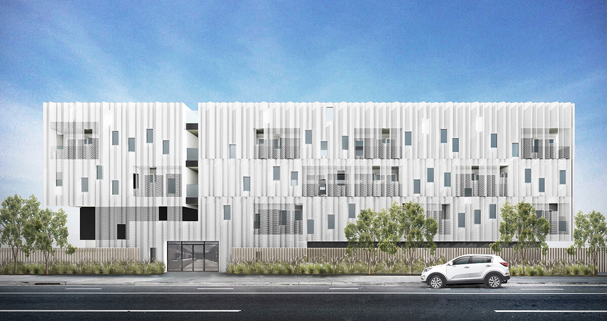 A modern white building with a textured, wavy facade, featuring balconies and large windows, stands behind greenery and a fence. A white car is parked on the street in front under a blue sky.