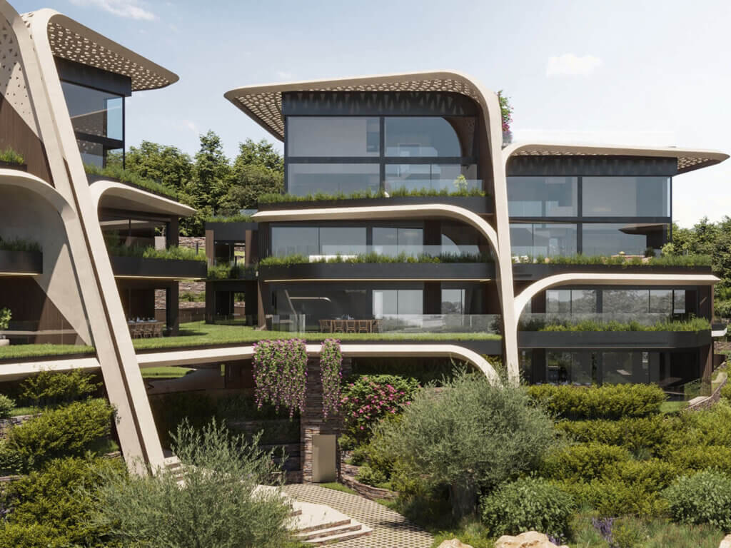 Modern multi-story building with large glass windows, curved architectural elements, and lush greenery on balconies and surrounding landscape, set against a backdrop of trees and a blue sky.